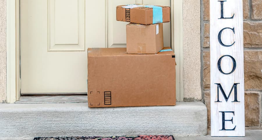 Deliveries on the front porch of a house with a welcome sign in Houston